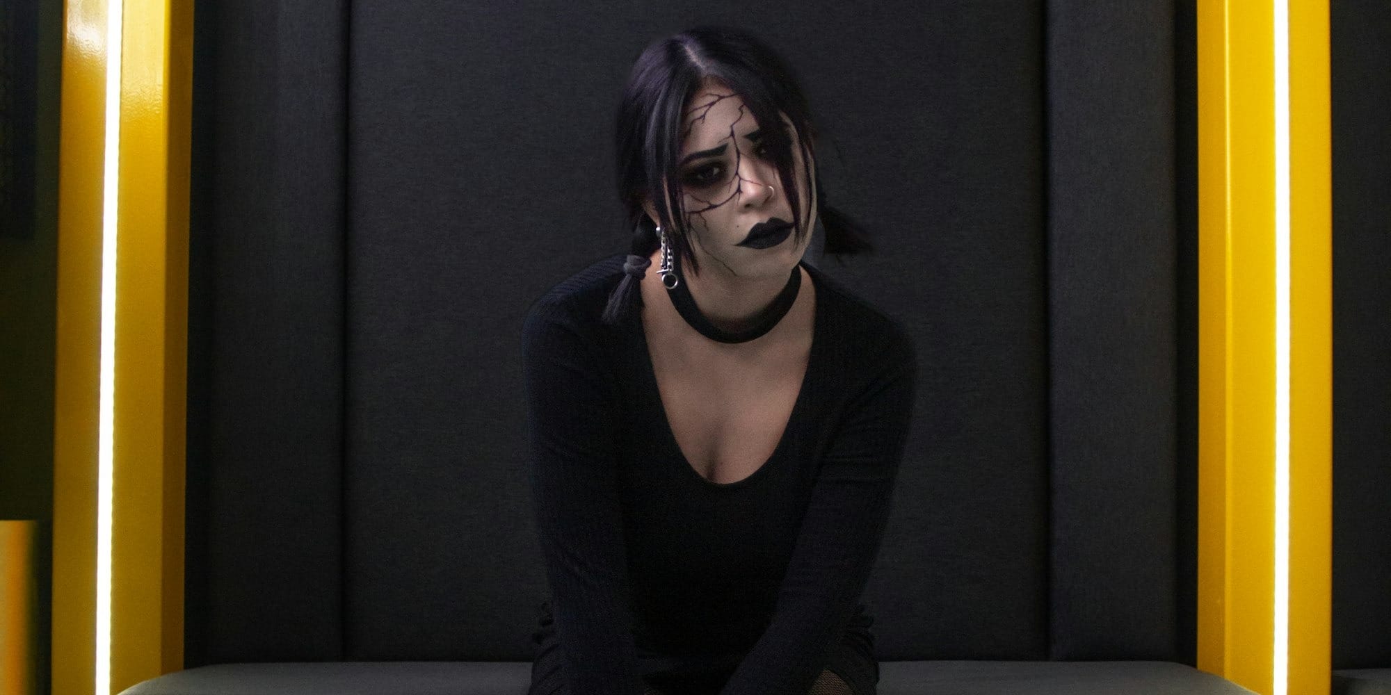 a woman sitting on a black couch in a room